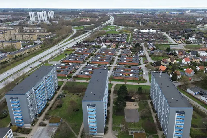 Drönarbild på höghusområde intill motorväg
