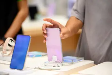 Person som är spekulant på att köpa en telefon i en elektronikbutik